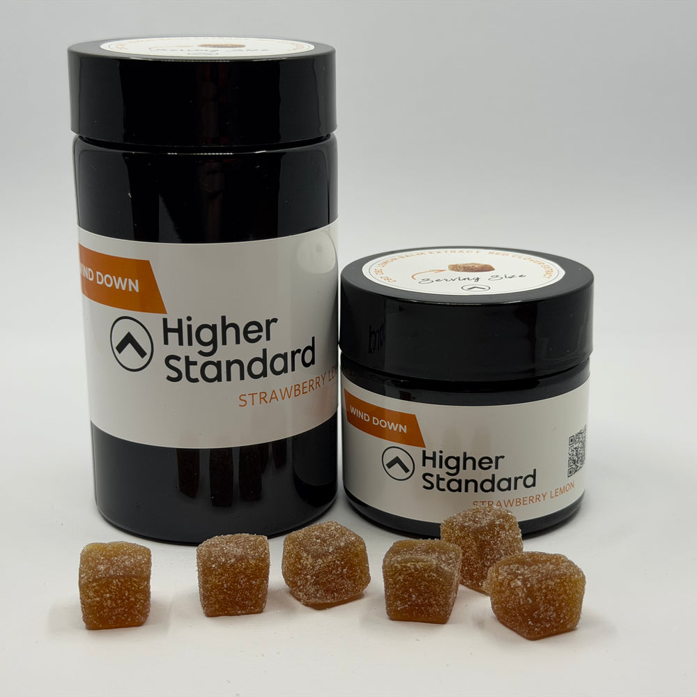Higher Standard Wind Down calming gummies with jar and strawberry flavored CBD relaxation gummies.